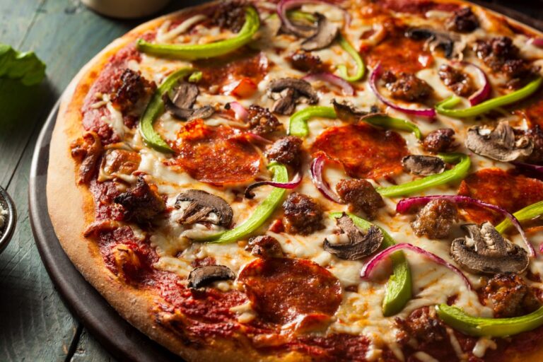A pizza that has been deliciously prepared and has many toppings on it.