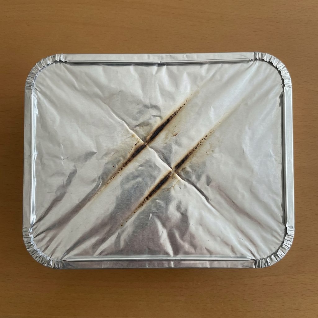 The Oven Rack That Left Two Parallel Marks on the Bottom of the Foil